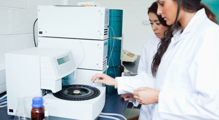 Students using a centrifuge in a laboratory